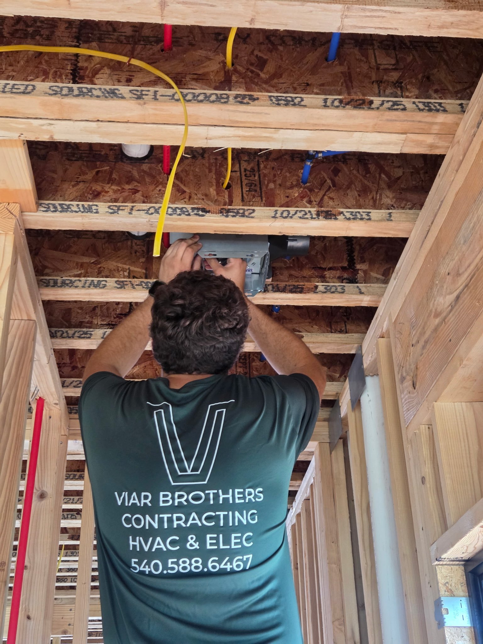 A certified technician from Viar Brothers HVAC & Electric repairs a residential circuit breaker panel to ensure safe power distribution for a home in the Roanoke Valley.