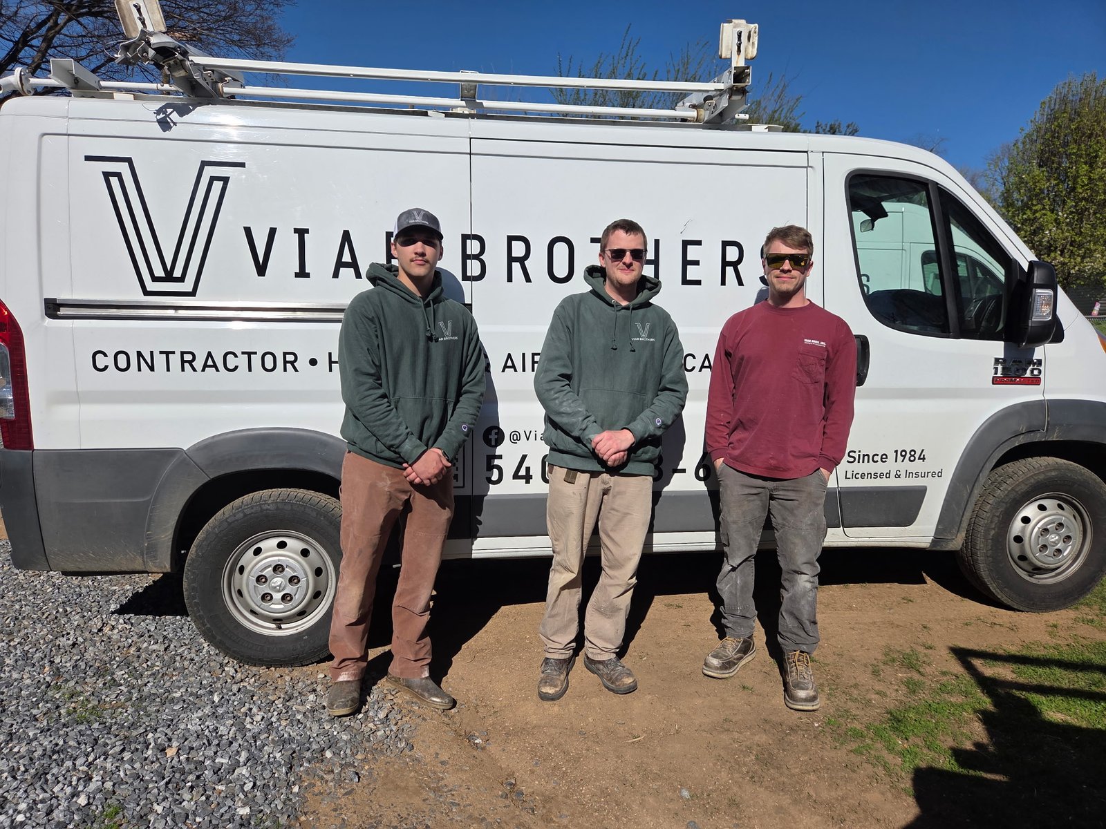 Three Viar Brothers HVAC technicians standing in front of a Viar Brothers service van